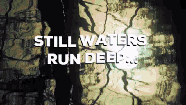 the words still waters run deep are displayed on a wall