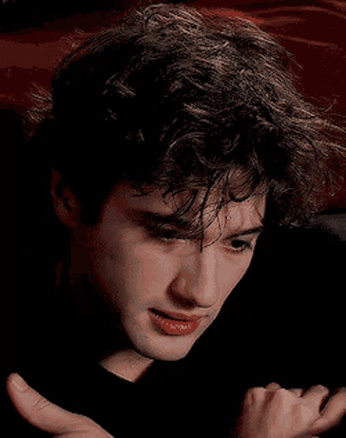 a close up of a man 's face with a hand on his shoulder