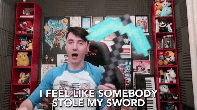 a man in a blue shirt is holding a minecraft diamond pickaxe and says i feel like somebody stole my sword
