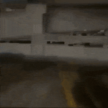 a person is walking in a parking garage with a yellow line on the ground .