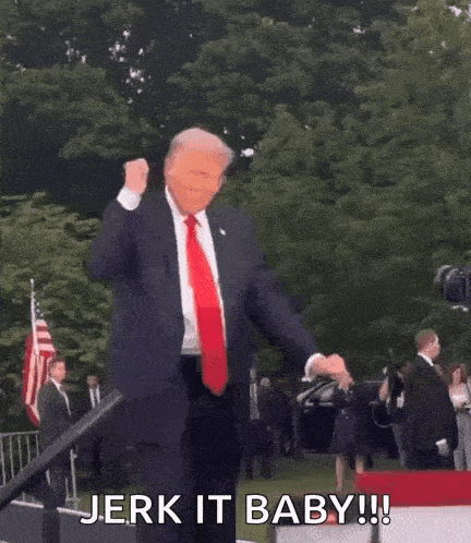 a man in a suit and tie is dancing in front of a crowd and says jerk it baby .