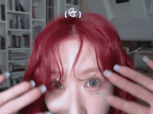 a woman with red hair has a sticker on her forehead that says e
