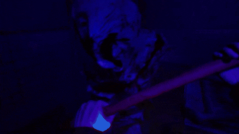 a person is holding a glow in the dark object in their hand .