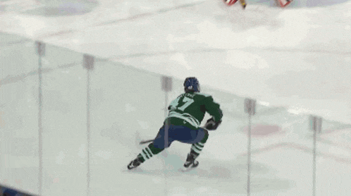 a hockey game is being played in massachusetts and the goalie is wearing number 24