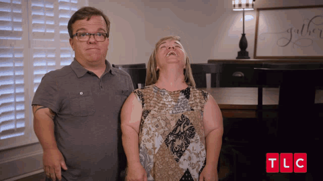 a man and a woman standing next to each other with tlc written on the bottom right