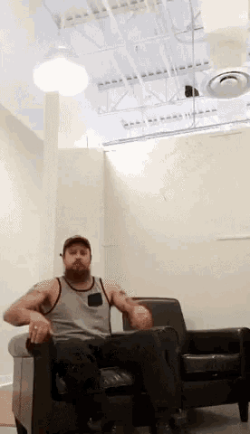 a man sits in a chair in front of a white board that says " patrick "