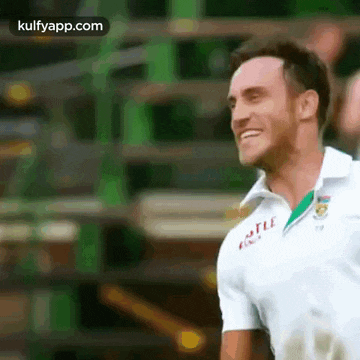 a close up of a man wearing a white shirt and smiling .