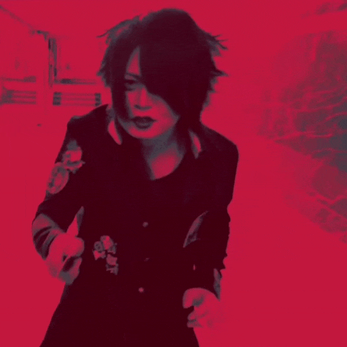 a person with long black hair and a red background