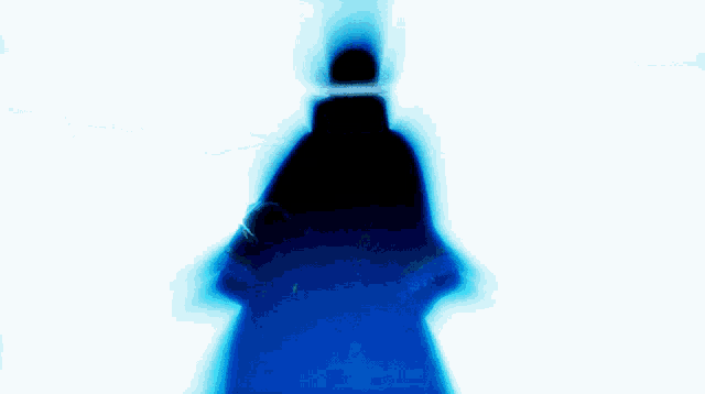 a silhouette of a person in a dark room with a blue background