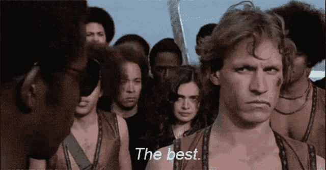 a man is standing in front of a group of people and says the best