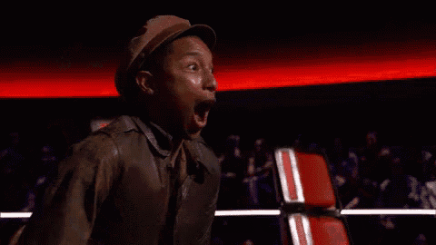 a man is screaming with his mouth open and his hands up .