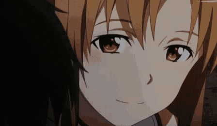 a close up of a girl 's face with brown eyes and a smile on her face .