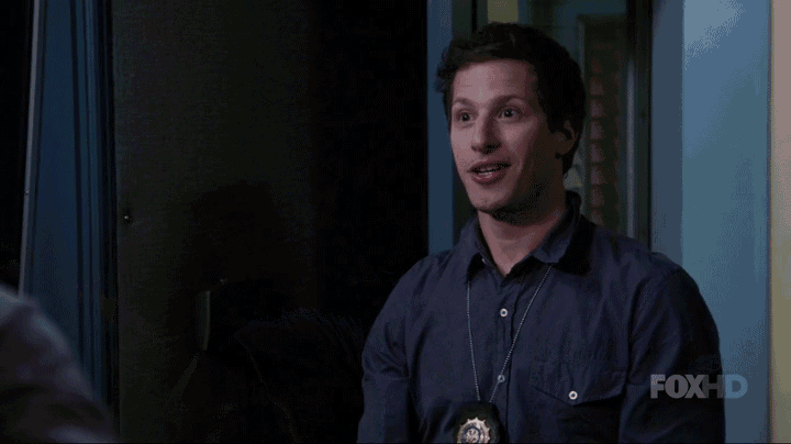 a man with a badge on his neck is making a funny face in front of a sign that says fox hd