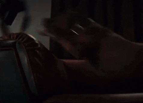 a blurry picture of a person in a dark room with a door in the background .