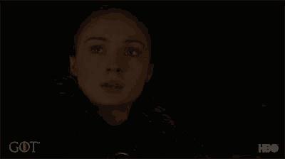 a close up of a woman 's face in a dark room with the word got on the bottom