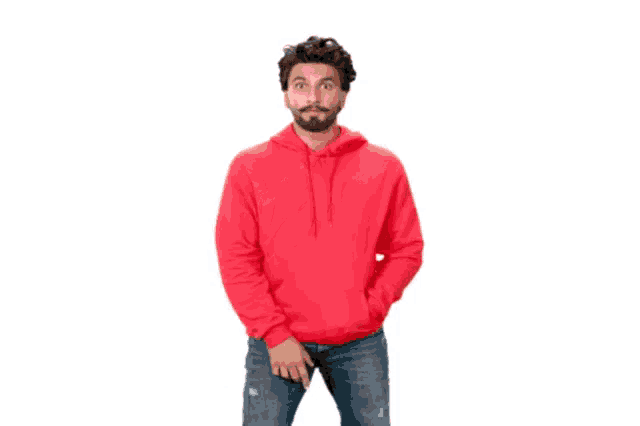 a man in a red hoodie and jeans is making a funny face