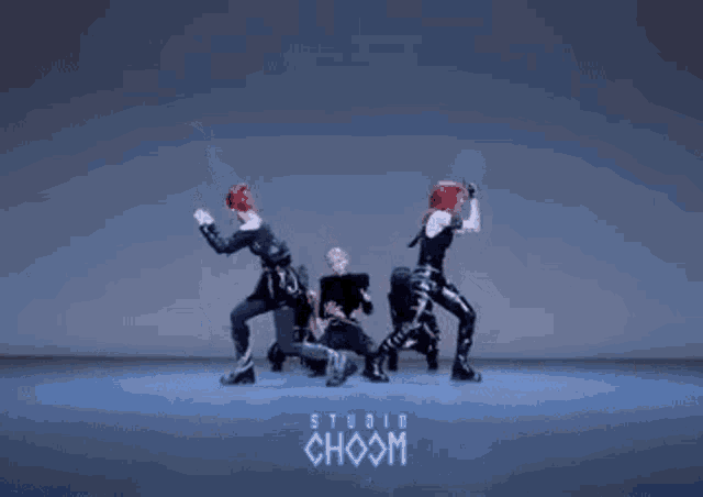 a group of young women are dancing in front of a studio choom logo