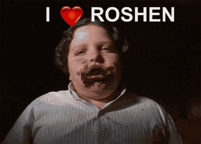 a boy with chocolate on his face and the words i love roshen above him