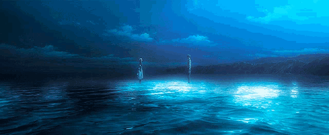 two people standing in the middle of a large body of water