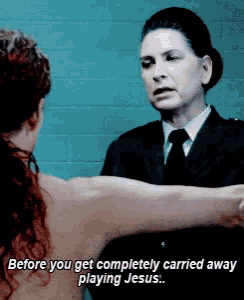 a woman in a suit and tie is talking to another woman with the words before you get completely carried away playing jesus below her