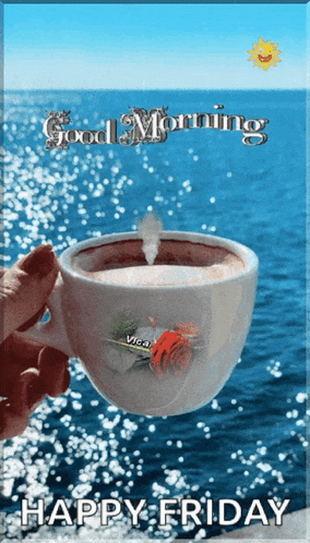 a person holding a cup of coffee in front of the ocean with the words good morning happy friday