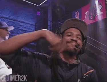a man wearing headphones and a hat with the word dimer2k written on the bottom