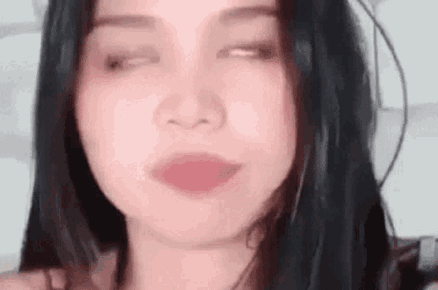 a close up of a woman 's face with her eyes closed .