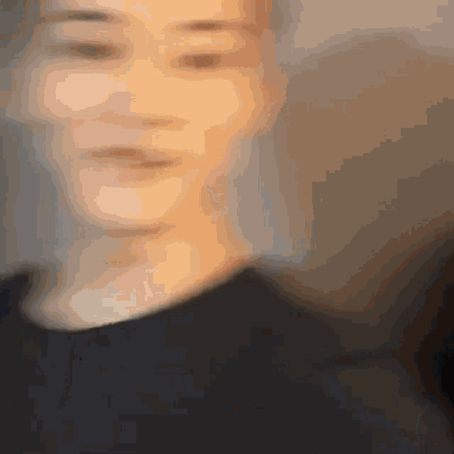 a blurry picture of a person 's face with their eyes closed