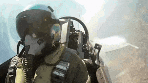a fighter jet pilot wearing a helmet and gas mask is flying through the air