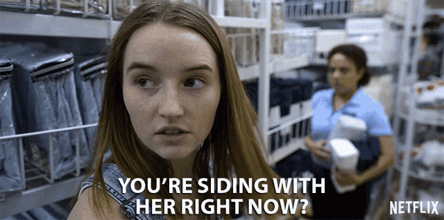 a woman in a store with the words " you 're siding with her right now " above her