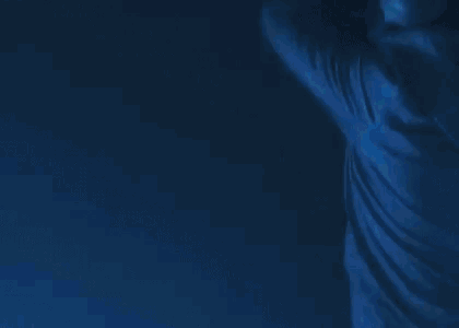a broken windshield of a car with a blue light shining on it