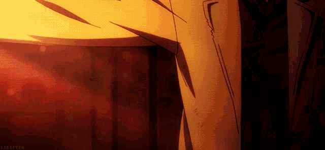 a man in a suit is standing in front of a wall with a red light behind him ..