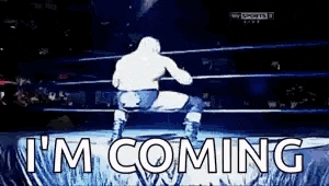 a wrestler is standing in a ring with the words `` i 'm coming '' written on it .