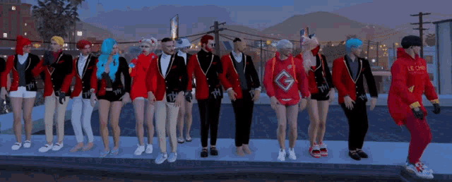 a group of people standing on a sidewalk with one wearing a red hoodie with the letter g on the front