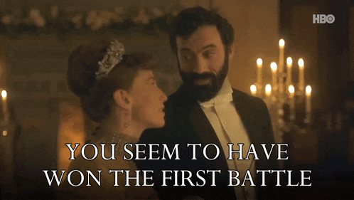 a man in a tuxedo stands next to a woman in a tiara with the words you seem to have won the first battle