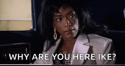 a woman is sitting in the back seat of a car and asking why are you here ike ?