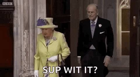 the queen is wearing a yellow dress and a hat and walking next to a man in a suit .