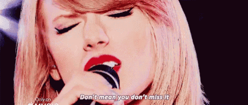 a close up of a woman singing into a microphone with the words `` don 't mean you don 't miss it ''