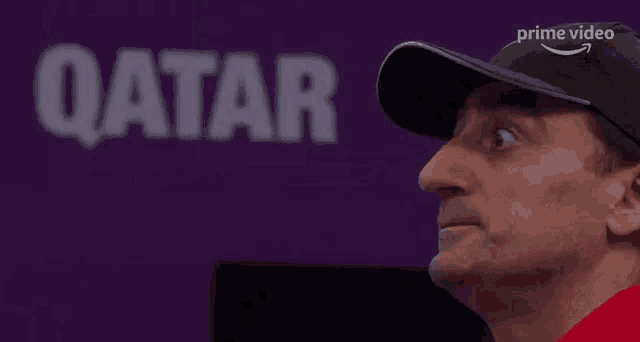 a close up of a man 's face with an amazon prime video logo on his hat