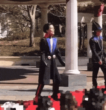 a woman in a blue jacket is standing next to a man in a black jacket