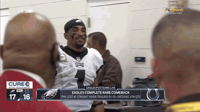 an eagles football player is talking to a group of men