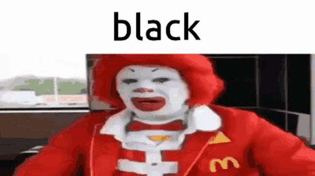 a mcdonald 's clown is wearing a red jacket and a red hat and is sitting in a car .