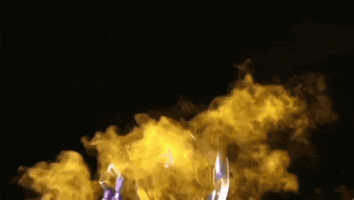 a toy robot is surrounded by smoke and fire on a black background .