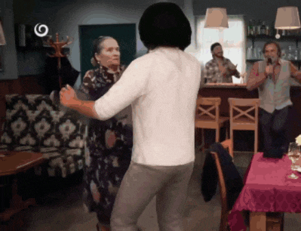 a man and a woman are dancing in a room with a circle around them