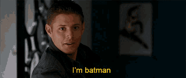 a man says i 'm batman in front of a picture