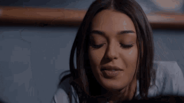 a close up of a woman 's face with her eyes closed and her mouth open