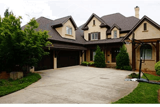 a large house with a basketball hoop in the driveway