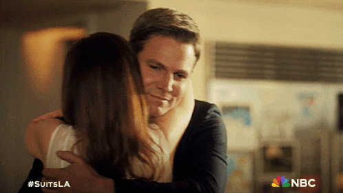 a man is hugging a woman with the nbc logo in the corner