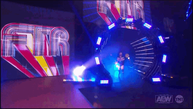 a wrestler is walking through a tunnel with a aew logo on the bottom