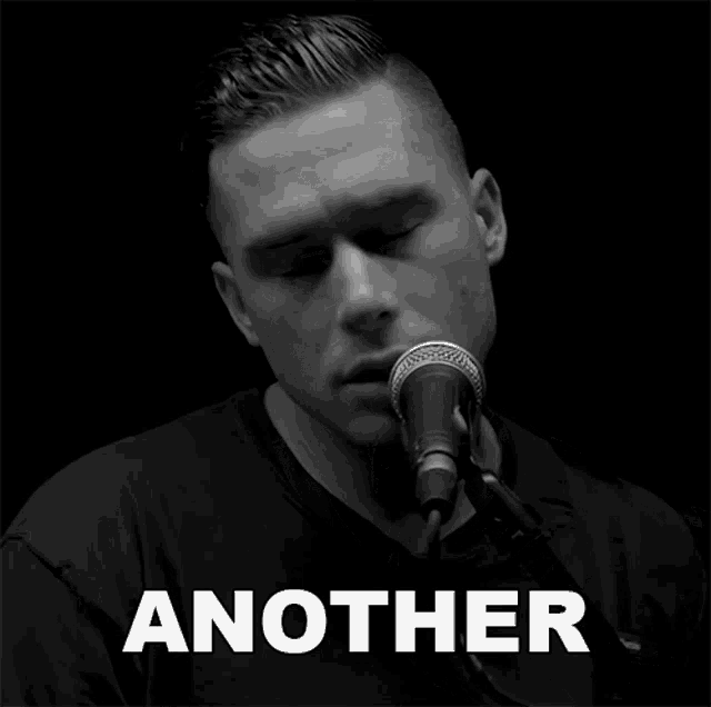a black and white photo of a man singing into a microphone with the word another above him
